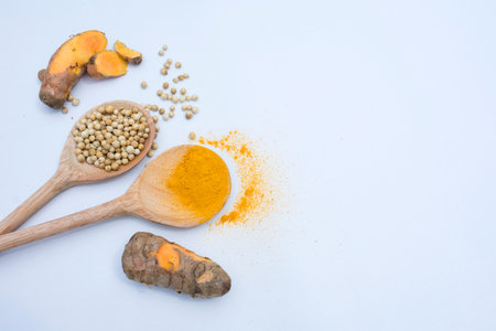 Turmeric, turmeric powder and coriander seeds on white backgroundの写真素材