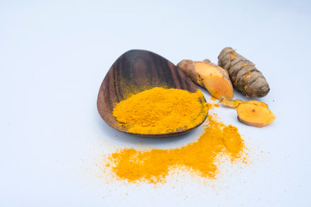 Turmeric powder and turmeric root on white background.の写真素材