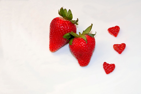 Fresh strawberries with heart shaped berriesの写真素材