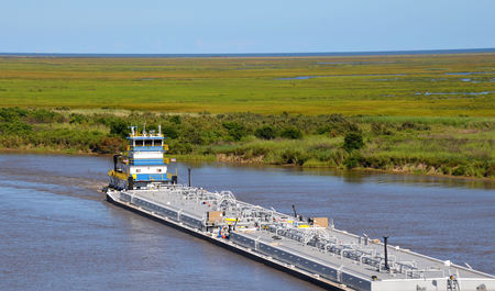 Oil barge being pushed by tugboatの写真素材