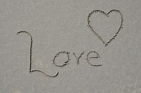 Love and Heart written in pacific coast sand.  Symbol of Love in travel destination location.の写真素材