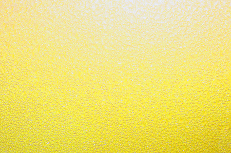 Yellow textured background. Bright, cheerful pastel yellow backdrop. Excellent springtime, summer or Easter theme.の写真素材