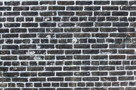 Brick wall, excellent rustic abstract background or backdrop. Color and detail in this beautiful vintage brick wall, built years ago. Cracked and aged surface of textured brick wall.の写真素材