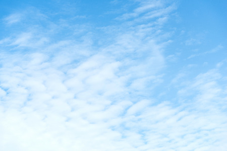 A blue sky with white cloudsの写真素材