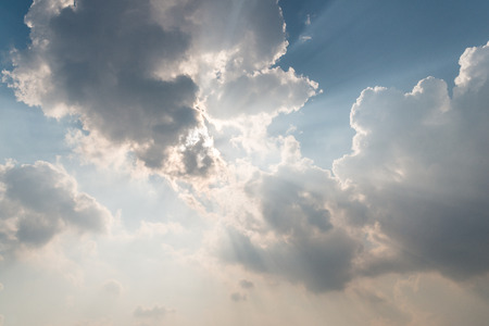 Beautiful background bright sun shines through clouds, light rays and other atmospheric effectの写真素材