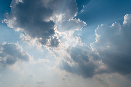 Beautiful background bright sun shines through clouds, light rays and other atmospheric effectの写真素材