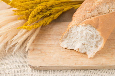 French bread baguettes on bread board on burlap textureの写真素材