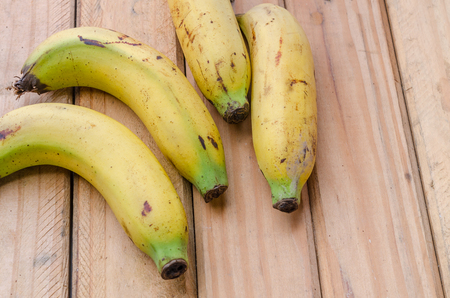 Fresh organic banana on wooden plate, selective focus banana in rustic styleの写真素材