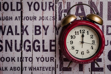Red retro alarm bell clock on texture backgroundの写真素材