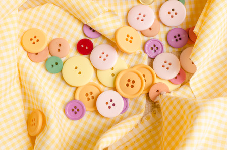 Colorful cloth button on tablecloth backgroundの写真素材