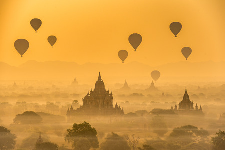 Hot air balloons float over pagodas field at Old Bagan, Myanmarの写真素材