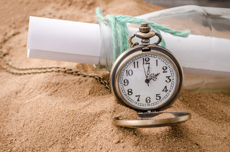 Vintage necklace watch on the sand beachの写真素材