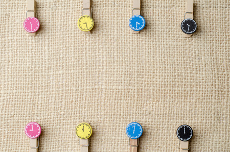 Wooden clothespins on burlap sack background.の写真素材