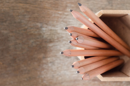 Close up of pencils in holder with wooden backgroundの写真素材