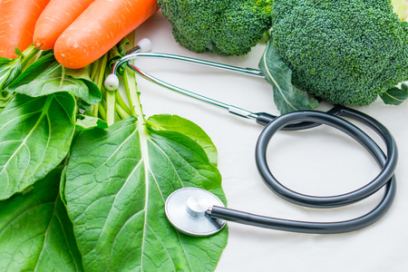 Fresh organic vegetable and stethoscope on white background.  Healthy food and fitness lifestyle conceptの写真素材