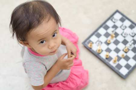 Asian little girl with chess game.の写真素材