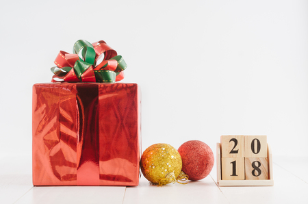 Cube calendar for new year 2018 with red gift box and decorations on white backgroundの写真素材