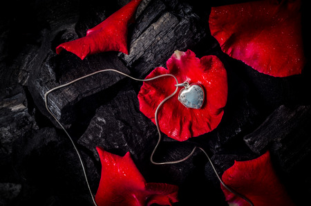 Silver heart  shape locket with necklace on black charcoal texture backgroundの写真素材