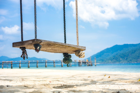 Wooden swing on tropical beach for summer and vacationの写真素材