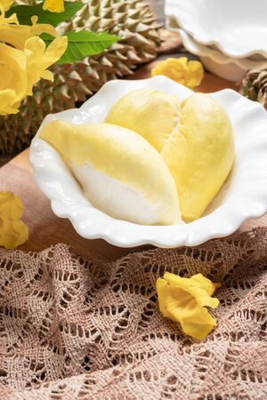 Fresh yellow durian fruit in a bowl and decorate with flowers. Sweet dessert concept.の写真素材
