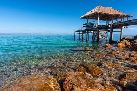 Wooden bridge over crystal clear aqua seaの写真素材