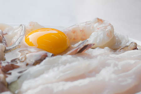 Raw chicken dinner with seafood.の写真素材