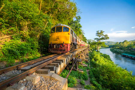 Thai Train on River Kwai Bridge of Kanchanaburi built in World War 2 , Thailandの写真素材