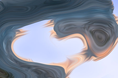 Beautiful abstraction of liquid paints in slow blending flow mixing together gentlyの写真素材