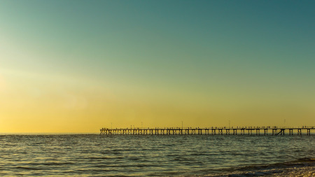 long jetty and vibrant color of sunsetの写真素材