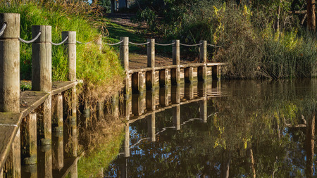 the reflection of fence on water surfaceの写真素材