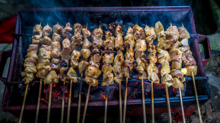 Traditional indonesia chicken satay skewer with bamboo stick grilled on the charcoalの写真素材
