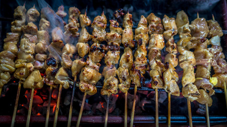 Traditional indonesia chicken satay skewer with bamboo stick grilled on the charcoalの写真素材