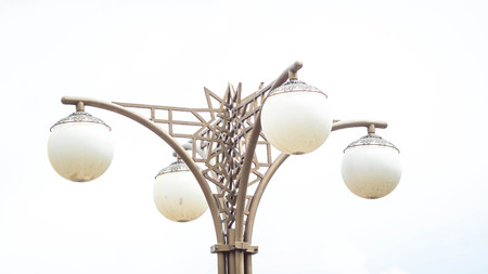 decorative outdoor lamppost with huge bulb with sky as the background