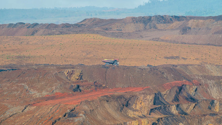 Open pit coal mining in Sangatta, Indonesia. Huge trucks are used to transport materials in this...