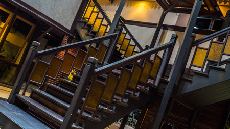 vintage dark brown wood staircase in the middle of a building. interior design conceptの写真素材