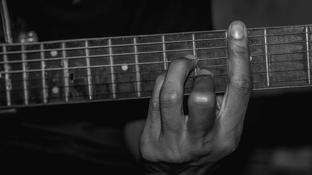 man playing acoustic guitar. selective focus with narrow depth of fieldの写真素材