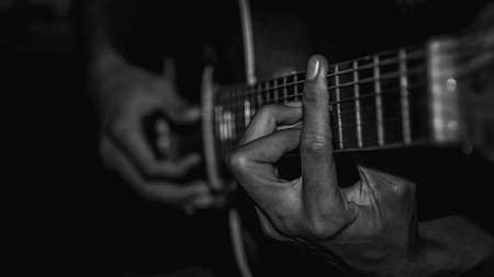 man playing acoustic guitar. selective focus with narrow depth of field