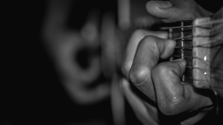 man playing acoustic guitar. selective focus with narrow depth of fieldの写真素材