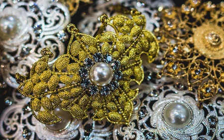 closeup of glamorous jewelry. Pile of gold, pearl, silver, gemstone jewelryの写真素材