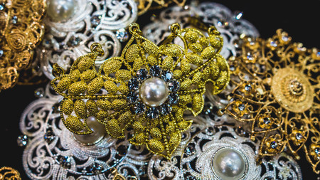 closeup of glamorous jewelry. Pile of gold, pearl, silver, gemstone jewelryの写真素材