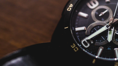 closeup of watch with chronometer on wooden background