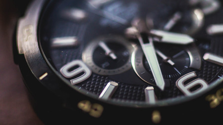 closeup of watch with chronometer on wooden background
