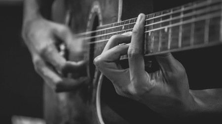 closeup of a man playing guitar. selective focus with narrow depth of fieldの写真素材