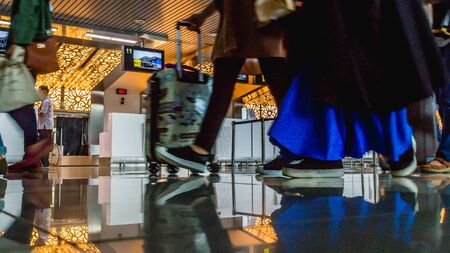 The activity in the airport terminal building, passenger with luggage trolley in front of check-in counter deskのeditorial素材