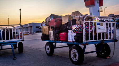 cart of baggage with air control tower as the backgroundのeditorial素材
