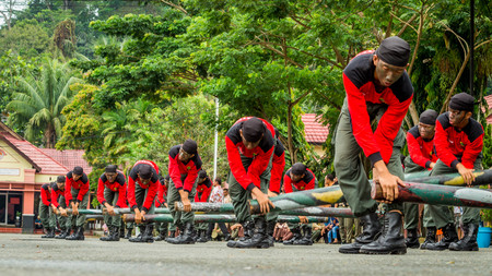 students of forestry vocational school of Samarinda performing military attraction on their...