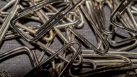 metallic triangular paper clip. office and school supply backgroundの写真素材