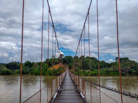 Suspension bridge that crossing Mentarang River, Malinau, outback of Borneo, Indonesia
