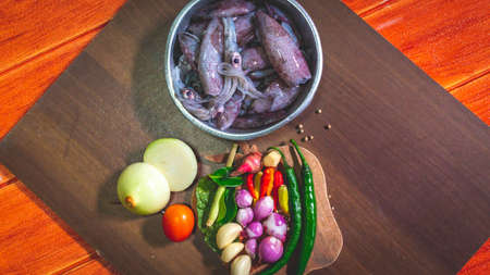 cuttlefish and spices on the cuttingboard. Preparation before cooking calamari