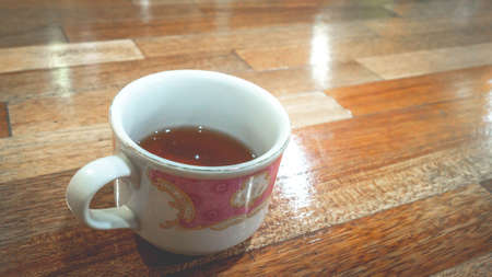 a cup of tea on a wooden tableの写真素材